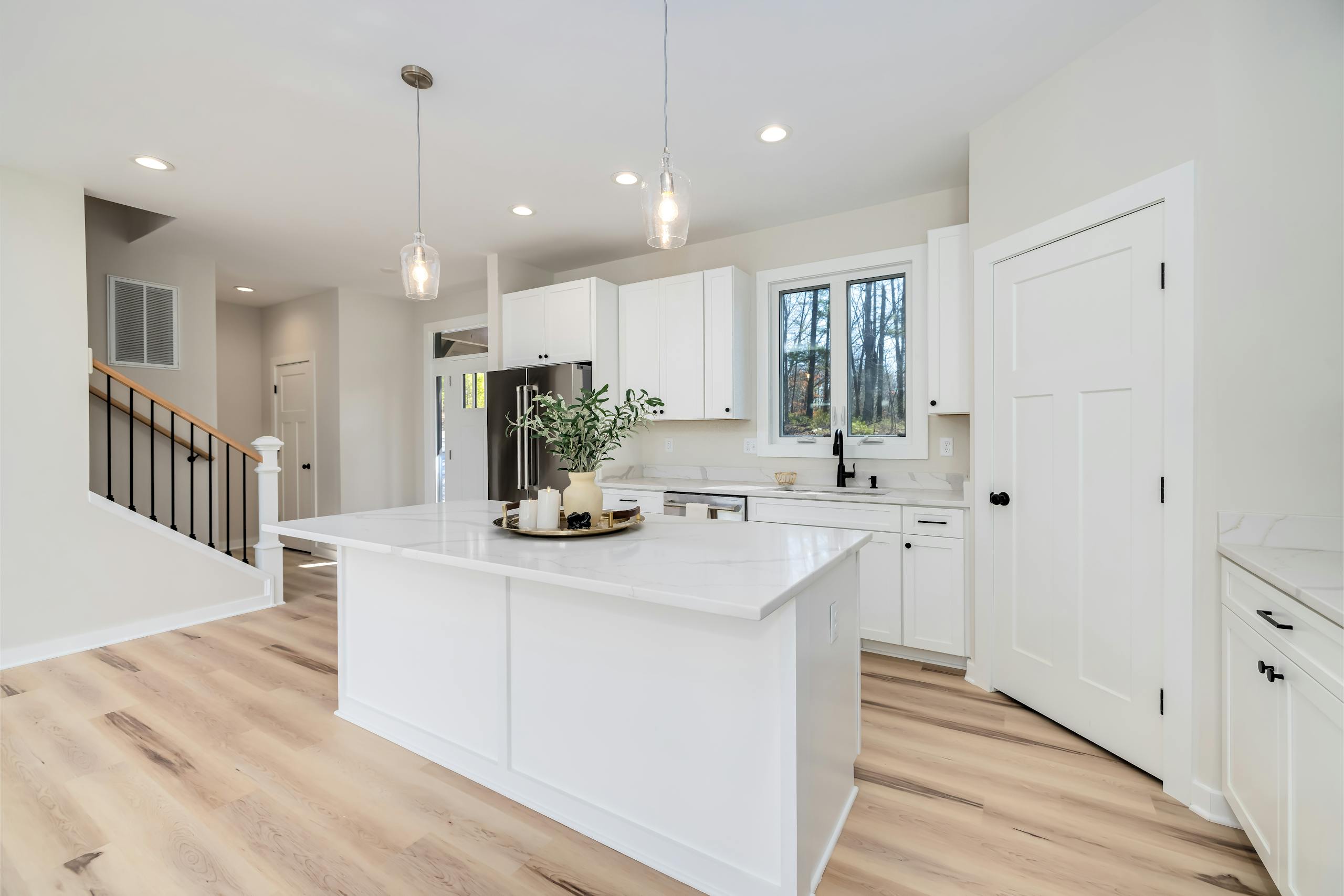 boca raton kitchen remodeling services featuring white cabinets and island, with minimalist decor.