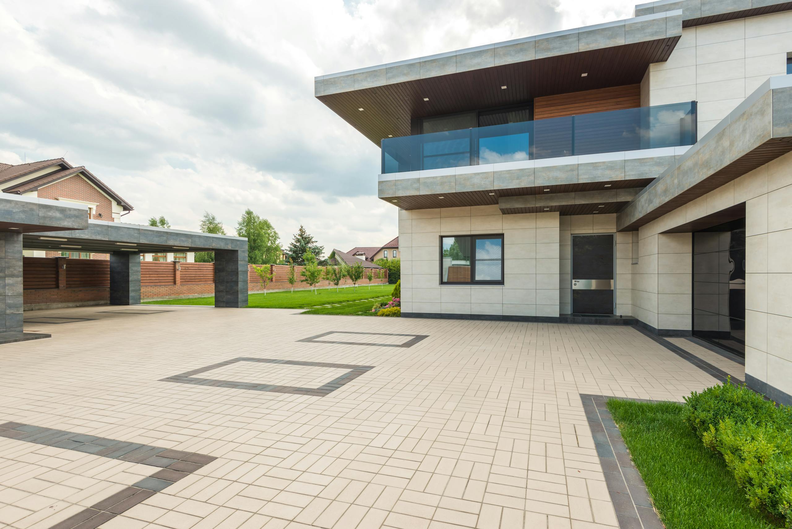 house remodeling services in boca raton with Contemporary residence with sleek design, large driveway, and landscaped yard.